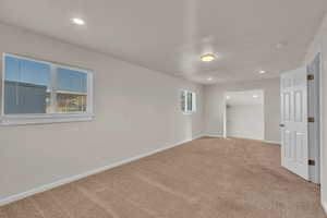 Unfurnished room featuring carpet flooring and a textured ceiling