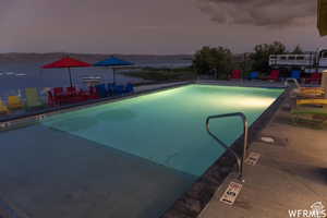 Pool at dusk with a patio