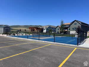 View of tennis court with a pergola