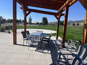 View of patio with a mountain view and a pergola