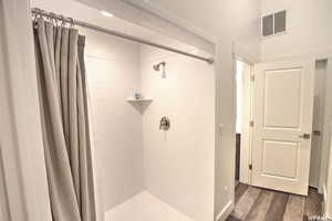 Bathroom with wood-type flooring and walk in shower