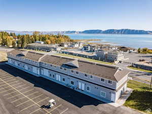 Drone / aerial view featuring a water and mountain view