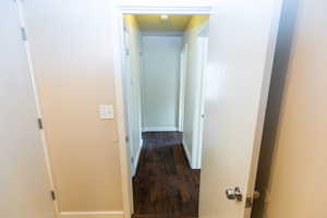 Corridor with dark wood-type flooring