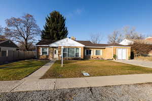 Single story home with a front yard