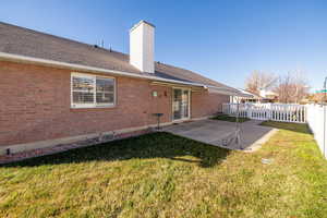 Rear view of house with a yard and a covered patio