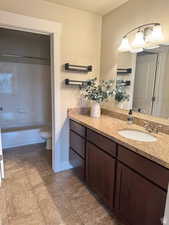 Full bathroom featuring vanity,  shower combination, and toilet