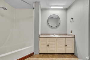 Bathroom with tile patterned flooring, vanity, and bathing tub / shower combination