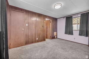 Master with light carpet and wooden walls