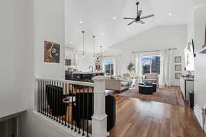 Interior space with ceiling fan, sink, dark hardwood / wood-style floors, and high vaulted ceiling