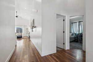 Corridor featuring dark hardwood / wood-style flooring and vaulted ceiling