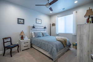 Bedroom with ceiling fan and carpet