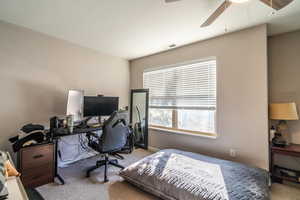 Bedroom featuring ceiling fan and light carpet