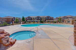 View of swimming pool featuring a pergola, a patio area, and a hot tub