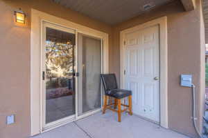 View of exterior entry with a patio area