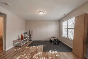 Exercise room featuring hardwood / wood-style floors