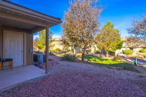 View of yard with central AC and a patio