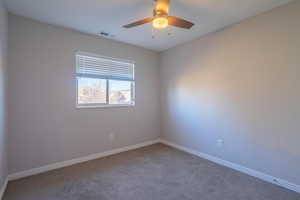 Unfurnished room featuring carpet and ceiling fan