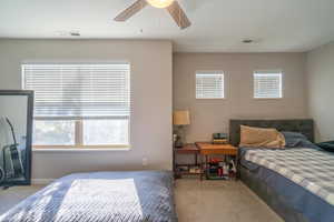 Bedroom with ceiling fan and carpet floors