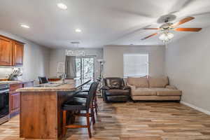 Kitchen with sink, an island with sink, and light hardwood / wood-style flooring