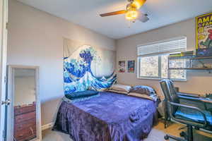 Carpeted bedroom with ceiling fan