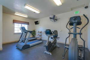 Workout area featuring a textured ceiling