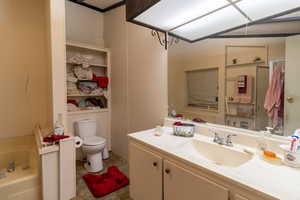 Bathroom with vanity, toilet, and a tub