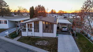 View of front of property featuring a carport and a yard