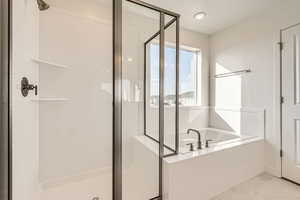 Bathroom featuring tile floors, a textured ceiling, and independent shower and bath