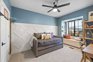 Carpeted bedroom with ceiling fan