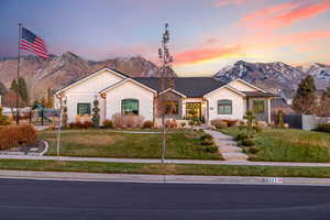 Ranch-style house featuring a mountain view and a yard