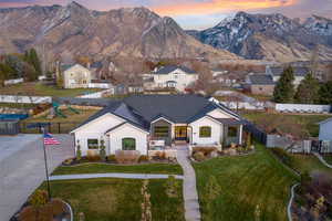 View of front facade featuring a mountain view and a yard