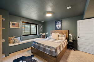 Carpeted bedroom with a textured ceiling