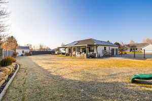 Exterior space featuring solar panels and a front lawn