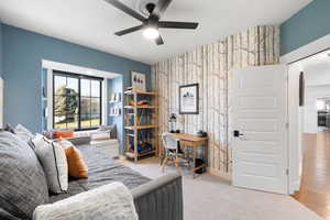 Living room with light hardwood / wood-style flooring and ceiling fan