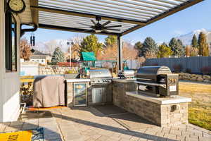 View of patio / terrace featuring a playground, area for grilling, and a mountain view