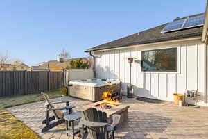 View of patio / terrace featuring a fire pit and a hot tub