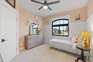 Carpeted bedroom with ceiling fan