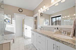 Bathroom featuring separate shower and tub, tile patterned flooring, and vanity