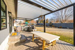 View of patio / terrace featuring a pergola, area for grilling, and exterior kitchen