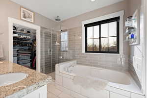 Bathroom featuring tile patterned flooring, vanity, and independent shower and bath