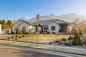 Single story home featuring a mountain view and solar panels