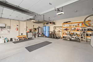 Garage featuring water heater and a garage door opener