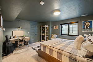 Bedroom with carpet flooring and a textured ceiling