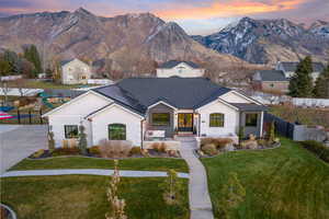 View of front of home featuring a mountain view and a yard