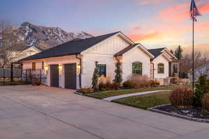 View of front of house with a mountain view and a garage