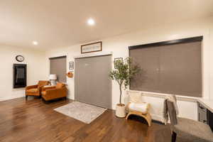 Living area with dark hardwood / wood-style flooring