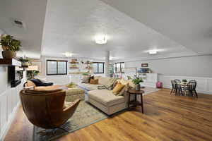 Living room with wood-type flooring and a textured ceiling