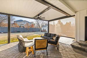 View of patio with an outdoor hangout area and ceiling fan