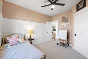 Carpeted bedroom with ceiling fan