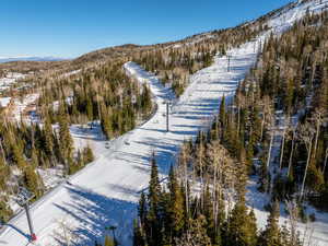 Snowy aerial view featuring a mountain view